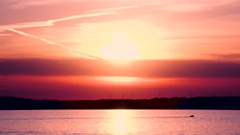 Sunset on a lake with orange sky Stock Footage