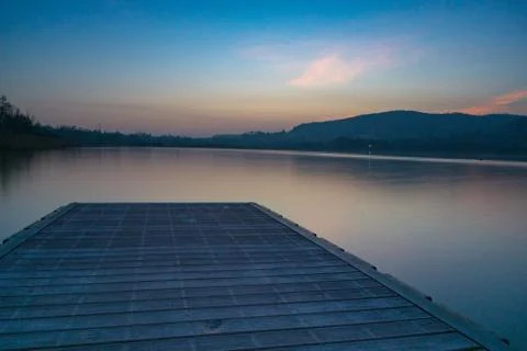Sunset on a lake with pier Stock Photos