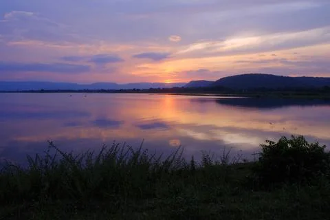 Sunset lake reflection mountain sky shoreline create tranquil scene over ca.. Stock Photos