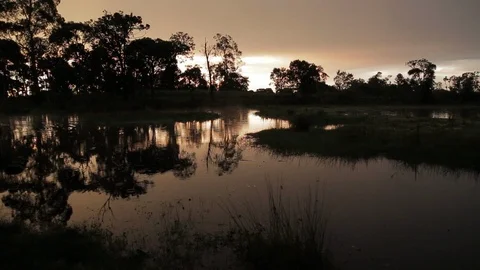 Sunset at a lake in a rural landscape Stock Footage 102787804