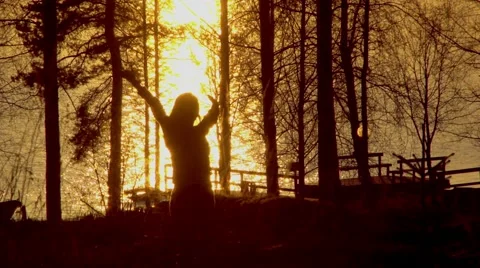 Sunset on the lake. Sunset reflected in water and silhouette of woman Stockbeeldmateriaal 67532910