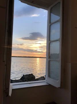 Sunset on the lake from a window in Bacoli Stock Photos