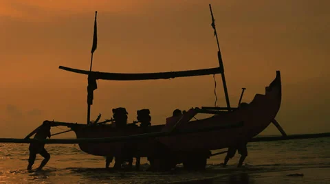 Sunset Landing 1 - Pulling a Fishing Boat Ashore with the Help of Friends Stock Footage 38059566