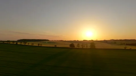 Sunset landscape across rolling crop fields during spring evening. Golden 스톡 동영상 342805603