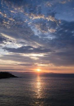 Sunset landscape between the clouds over the horizon of the sea. Stock Photos