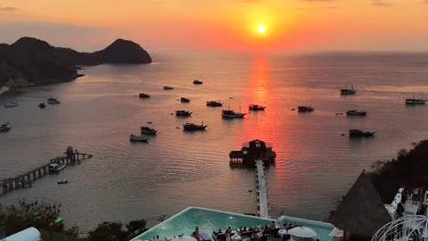 Sunset landscape in Labuan Bajo featuring a luxury resort pool 動画素材 341170655