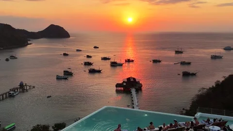 Sunset landscape in Labuan Bajo featuring a luxury resort pool Stock Footage 341170965