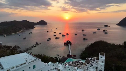 Sunset landscape in Labuan Bajo featuring a luxury resort pool Stock Footage 341170967