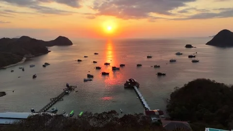 Sunset landscape in Labuan Bajo featuring a luxury resort pool Stock Footage 341171452
