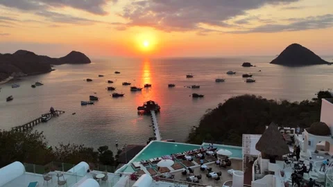 Sunset landscape in Labuan Bajo featuring a luxury resort pool Stock Footage 341171544