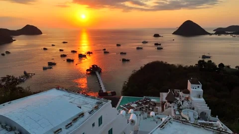 Sunset landscape in Labuan Bajo featuring a luxury resort pool Stock Footage 341172190