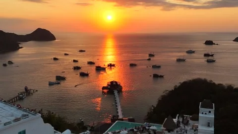 Sunset landscape in Labuan Bajo featuring a luxury resort pool Stock Footage 341172302