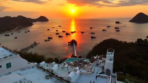 Sunset landscape in Labuan Bajo featuring a luxury resort pool Stock Footage 341172632