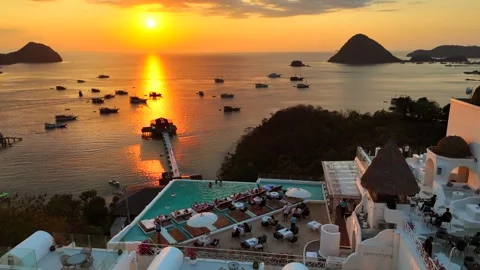 Sunset landscape in Labuan Bajo featuring a luxury resort pool Stock Footage 341192709