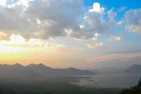 Sunset landscape with lake mountain range clouds Skadar Lake Stock Photos