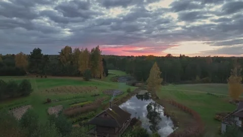 Sunset Landscape in Lithuania with Pond, Trees, and Garden Plot Stock Footage 316077842