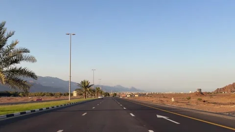Sunset landscape with mountains along the road in Fujairah, UAE. Scenic drive Stock Footage 306549883