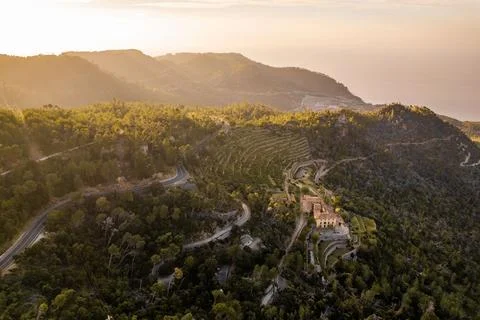 Sunset landscape of mountains full of green color near the sea Stock Photos