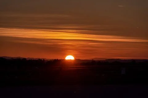 Sunset landscape with a plain wild grass field Stock Photos