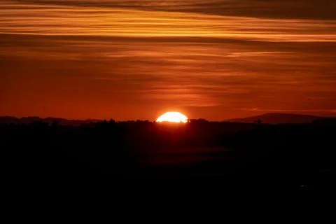 Sunset landscape with a plain wild grass field Stock Photos