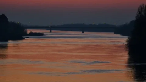 Sunset landscape of river with bridge on the horizon  Video stock 70299850