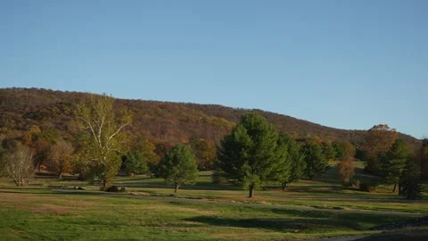Sunset Landscape Scene, Dusk Time Casts Long Shadows Over Gently Sloping Downs Stock Footage 323777116