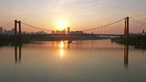 Sunset landscape with traffic flow of urban bridge across river Stock Footage 234464548