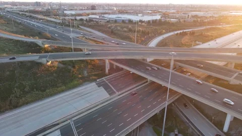 Sunset Layers: Drone Captures Multi-Level Highways and Passing Traffic Stock Footage 289560833