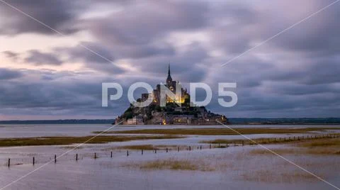 Sunset at Le Mont Saint Michelle in summer at high tide Stock Photos