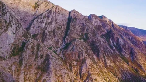 Sunset light and shadows on a mountain at the shore of Kotor Bay. Aerial shot Stock Footage 82838781