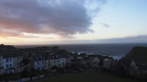 Sunset light on clouds over Devon village of Ilfracombe on coast Stock Footage 136864248