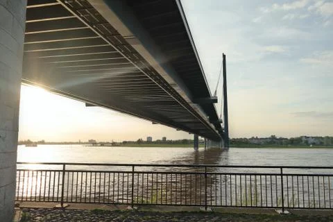 Sunset light coming from underneath the bridge over a river, Dusseldorf Germa Stock Photos