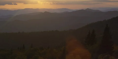 Sunset light falling on the silhouetted Blue Ridge Mountains Stock Footage 103398255