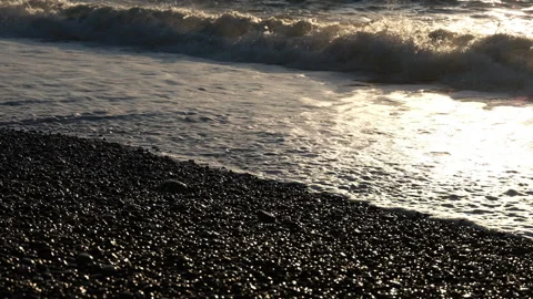 Sunset Light Glinting on Wet Beach Pebbles Video stock 347983678