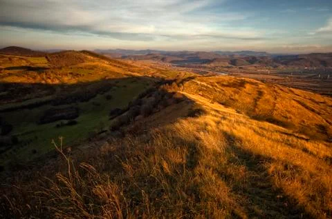 Sunset light on hill with dry grass in autumn Stock Photos