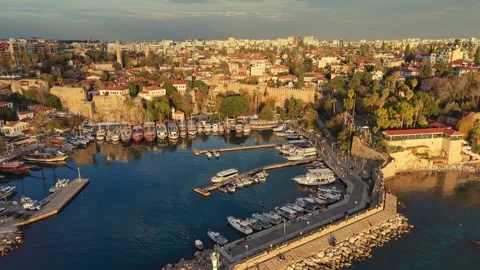 Sunset light hits ancient stone fortifications of old Kaleici harbor Stock Footage 341749951