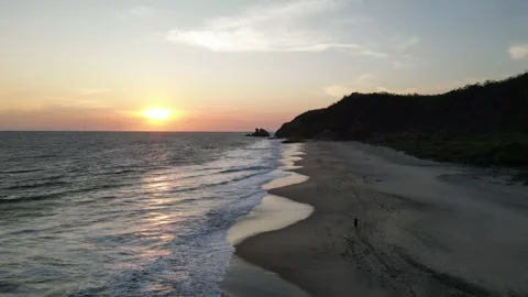 Sunset Light Illuminating Gentle Ocean Waves on Empty Sand Stock Footage 321707833
