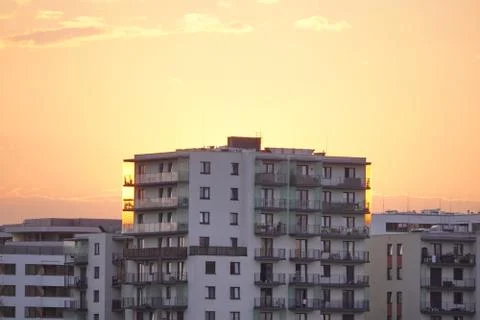 Sunset light on a modern multi-storey building. the sky without clouds of dif Stock Photos