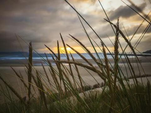 Sunset light over the beach in Aviles, Asturias, Spain Stock Photos
