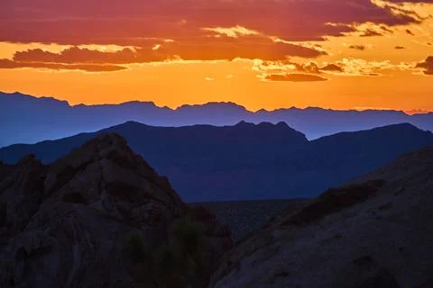 Sunset Light Over Layered Mountains and Rocky Formations at Golden Hour Stock Photos