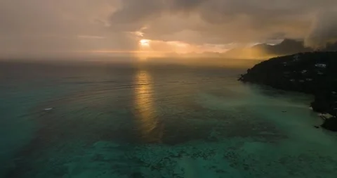 Sunset light over ocean with distant hills and cloudy sky. Seychelles, Mahe. Stock Footage 311492242