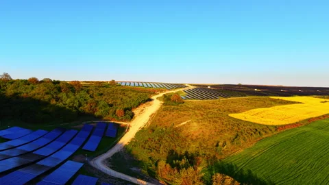 Sunset light over solar farm and rapeseed field, Bulgaria Stock-Footage 344691752