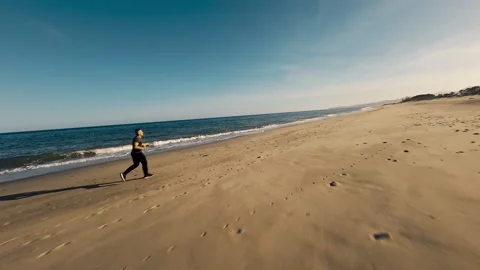 Sunset Light Over A Tired Running Man On The Beach Stock Footage 274706333