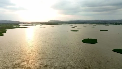 Sunset Light Over Wide Lake With Small Green Islands Stock Footage 342819964