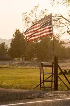 Sunset light passes through a waving U.S. flag near Terrebonne Stock Photos
