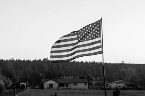Sunset light passes through a waving U.S. flag near Terrebonne Stock Photos