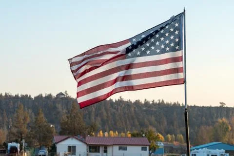 Sunset light passes through a waving U.S. flag near Terrebonne Stock Photos