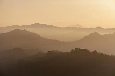 Sunset light reflected in the mist on countryside hills, Emilia Romagna, Italy, Stock Photos