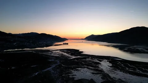 Sunset light reflecting on mountain estuary Stock Footage 257616888