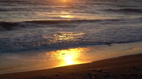 Sunset light reflecting on ocean waves at sandy Oregon beach, close up Stock Footage 159465663